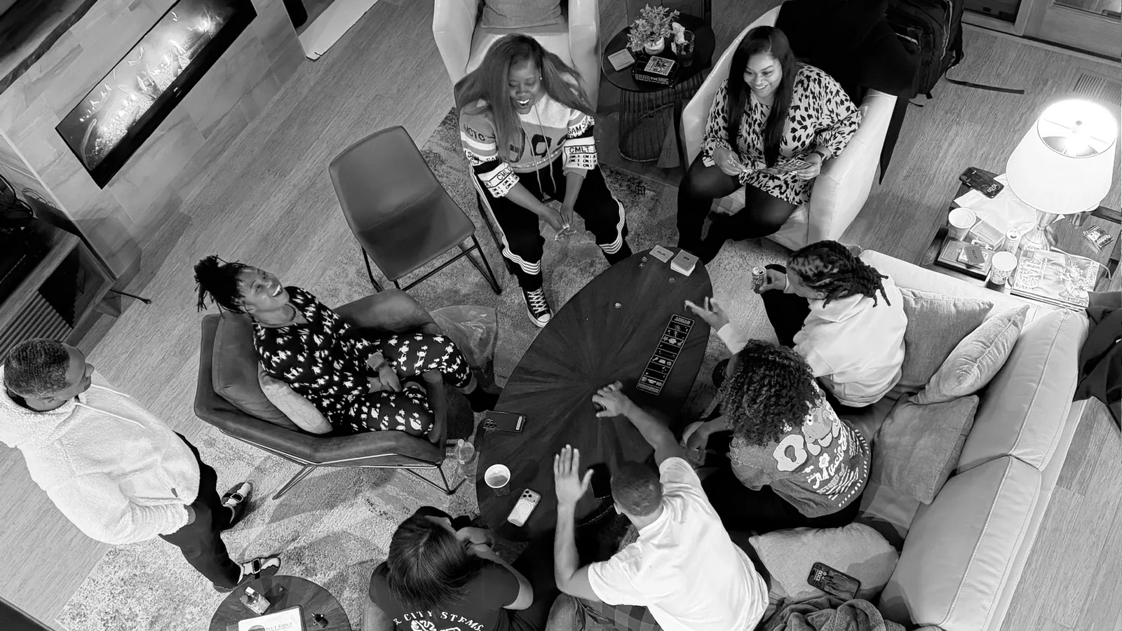 Friends gathered around a table mid-game, laughing